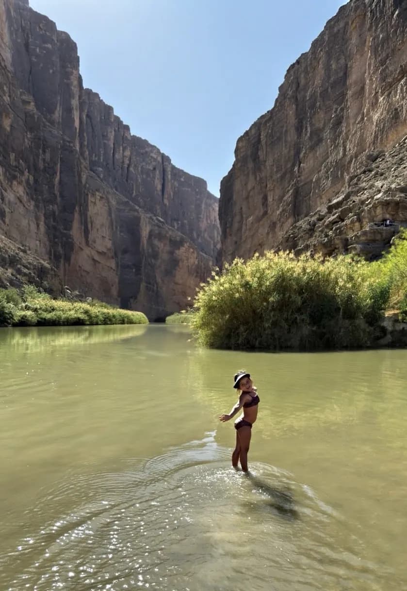 Our daughter wading in the Rio Grande beneath the canyon walls at Big Bend National Park