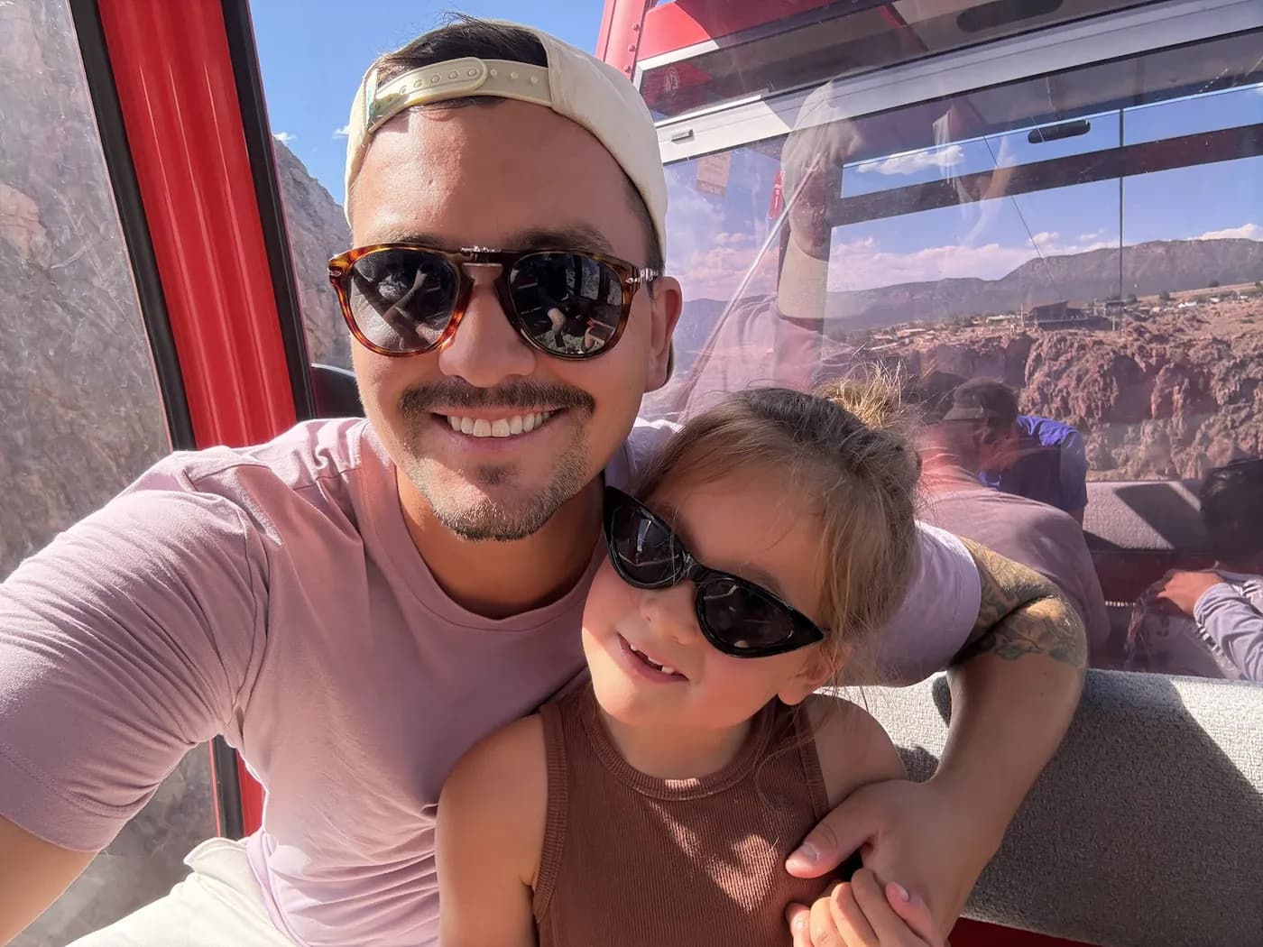 Cole and our daughter riding a gondola high over a river gorge