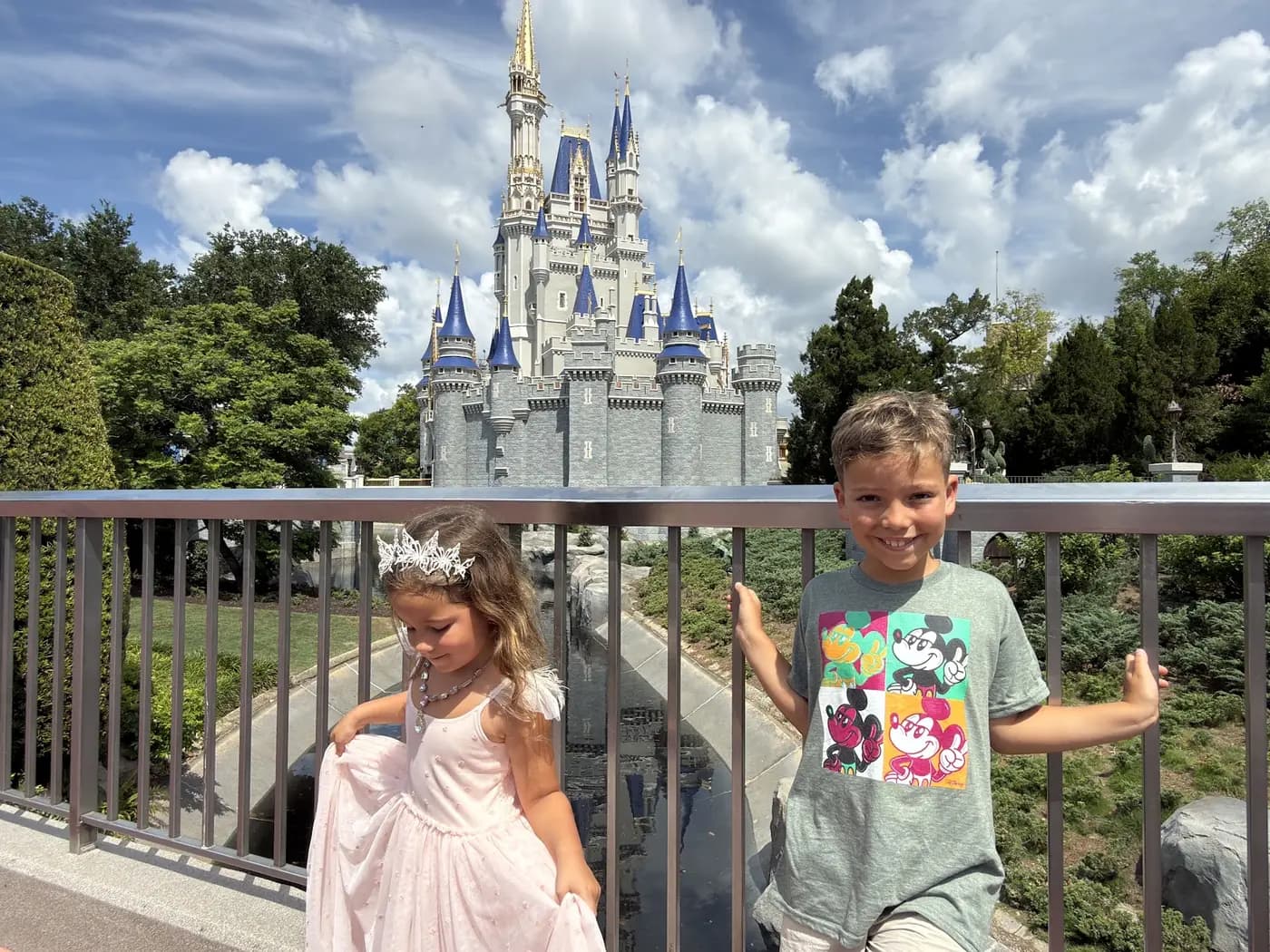 The kids posing in front of Cinderella Castle at Magic Kingdom